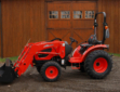 Tractor with Loader in front of barn