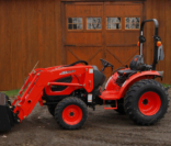 Tractor with Loader in front of barn