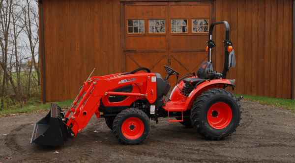 Tractor with Loader in front of barn